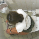 A daring cameraman stands on a toilet and peers over the stall wall to video-record this unsuspecting, Italian girl while she shits in a public restroom. Subtle fart, pooping and crackling sounds are heard before she wipes. Over 2 minutes.